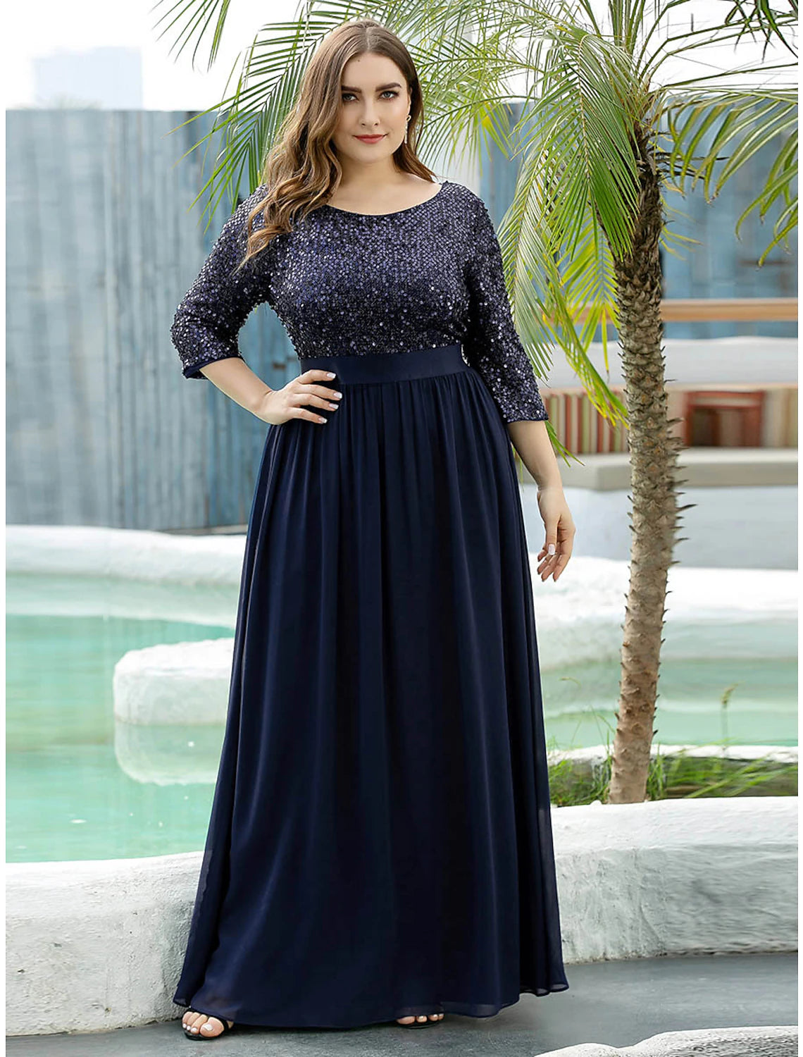 Elegant A-line Mother of the Bride dress with jewel neck and 3/4 sleeves, adorned with sequins.