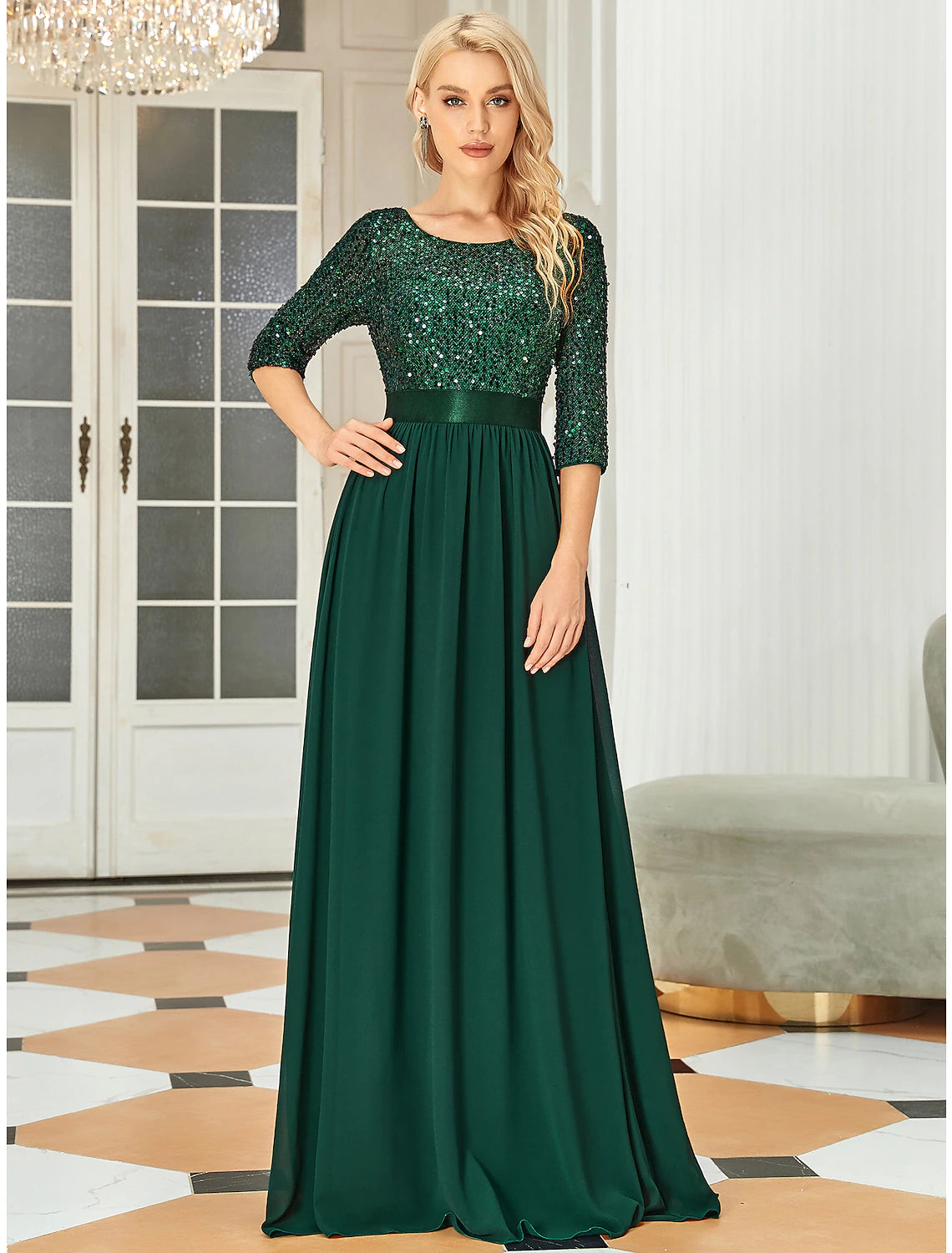 Back view of a sequined A-line gown, showcasing the floor-length tulle skirt.