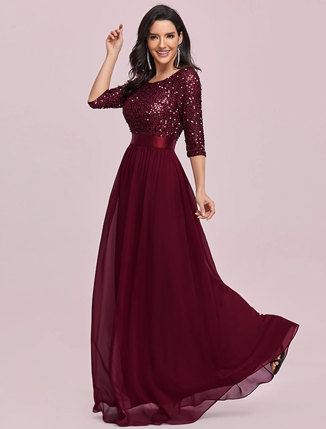 Detail of the jewel neckline and 3/4 length sleeve on a formal sequined dress.