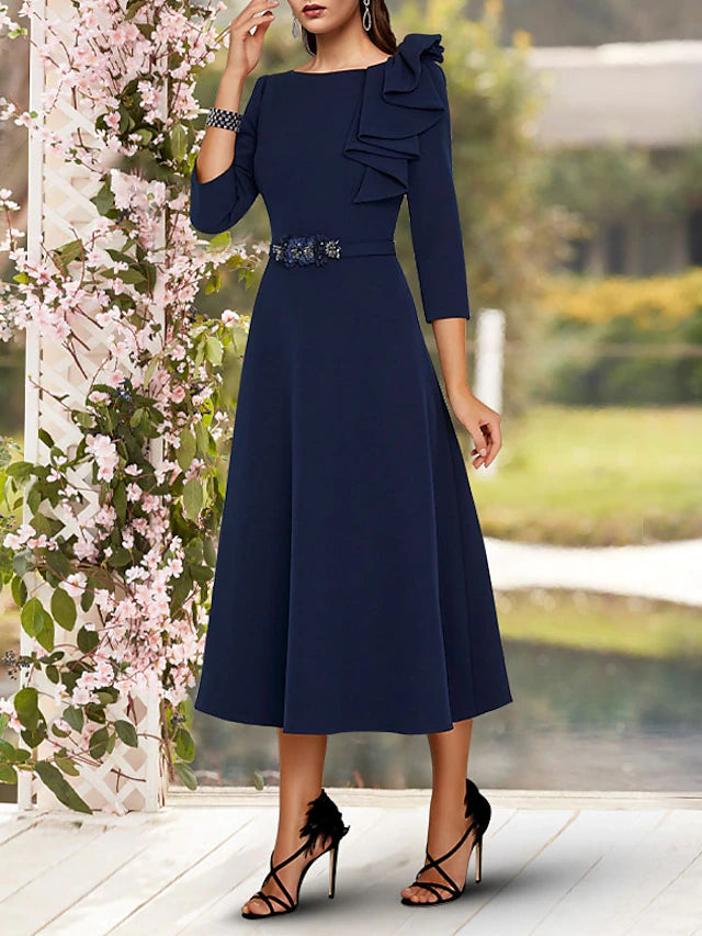 Tea length A-line dress featuring side draping and a sash.