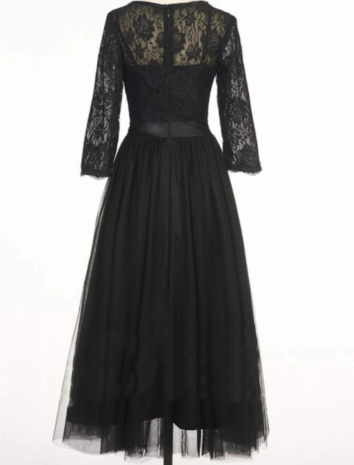 Woman posing in the black A-line dress, highlighting its flowy silhouette.