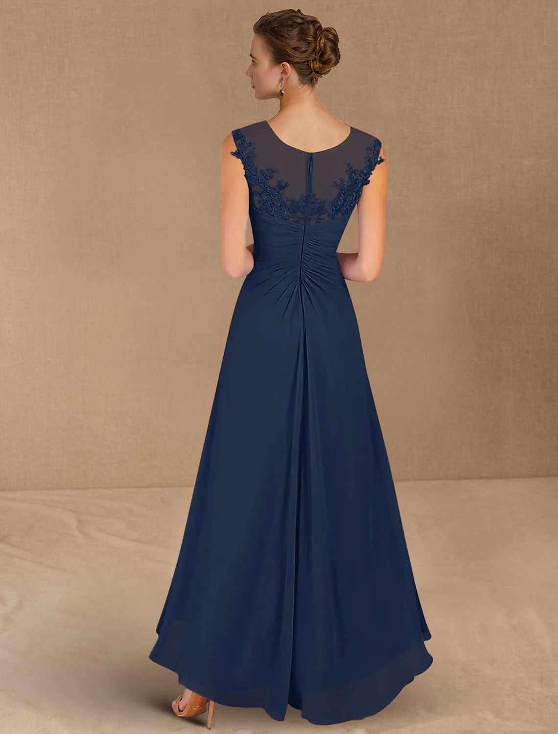 Back view of the A-line formal wedding guest dress in chiffon with intricate detailing.
