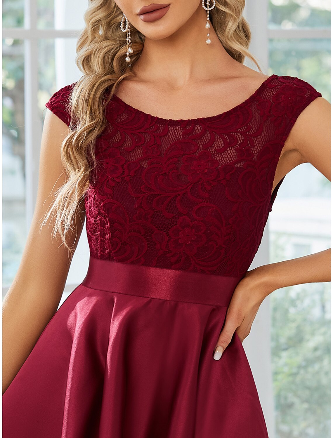 Model posing gracefully in the A-line satin dress.