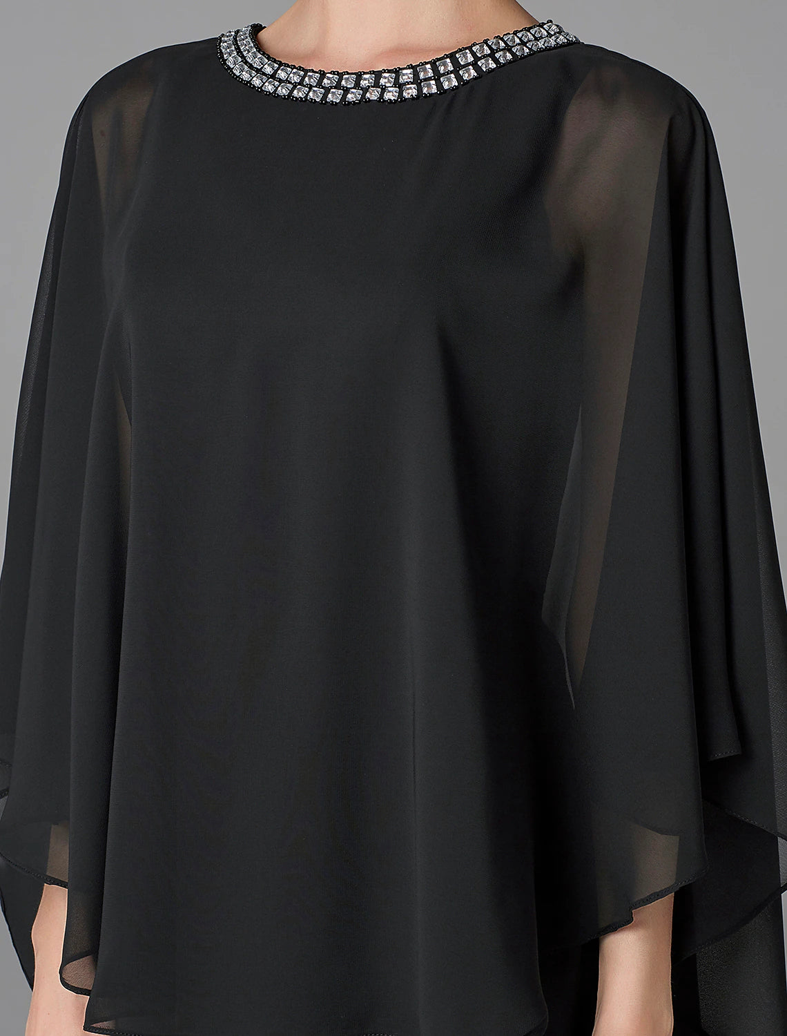 Close-up of the jewel neck and delicate beading on the chiffon dress.