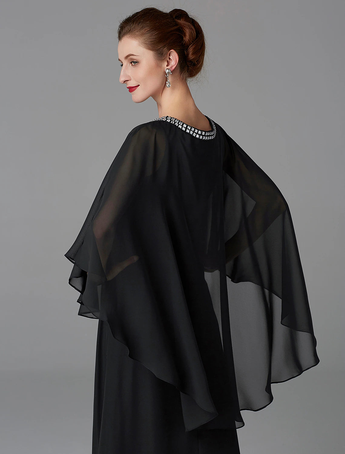 Detail of the flowing chiffon fabric and the cape design.