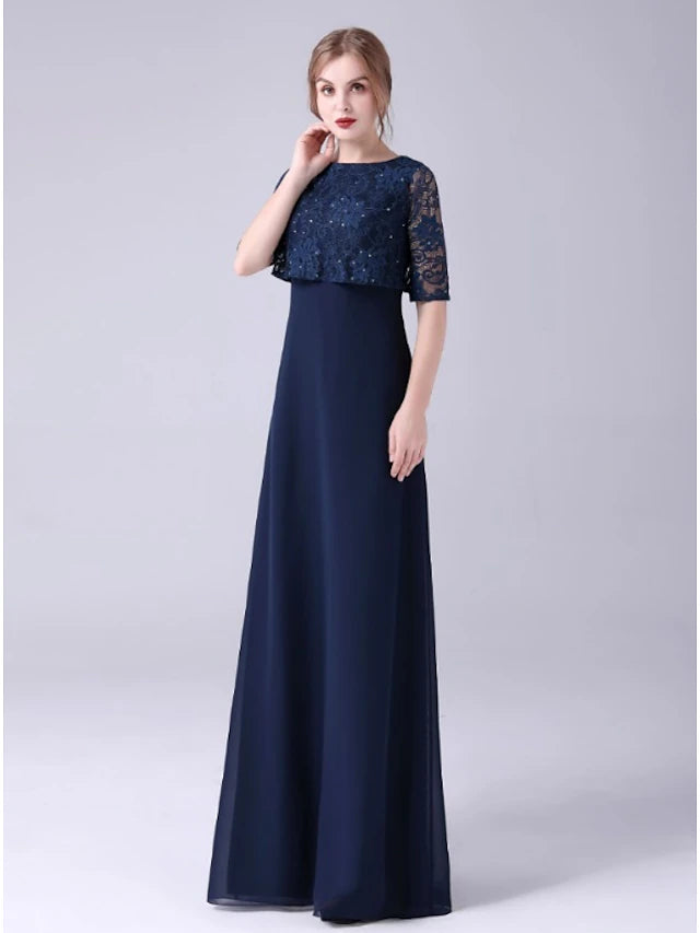 Close-up of the jewel neckline and half sleeves with lace and crystal embellishments on the dress.