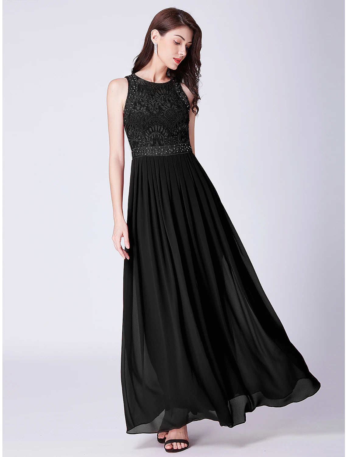 Side profile of the sleeveless jewel neck wedding guest dress.