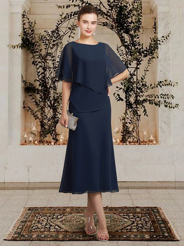 Plus size A-line mother of the bride dress with jewel neck and ruffles.