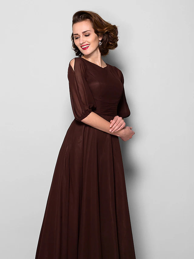 Close-up of the jewel neck and half sleeve on the chiffon dress.
