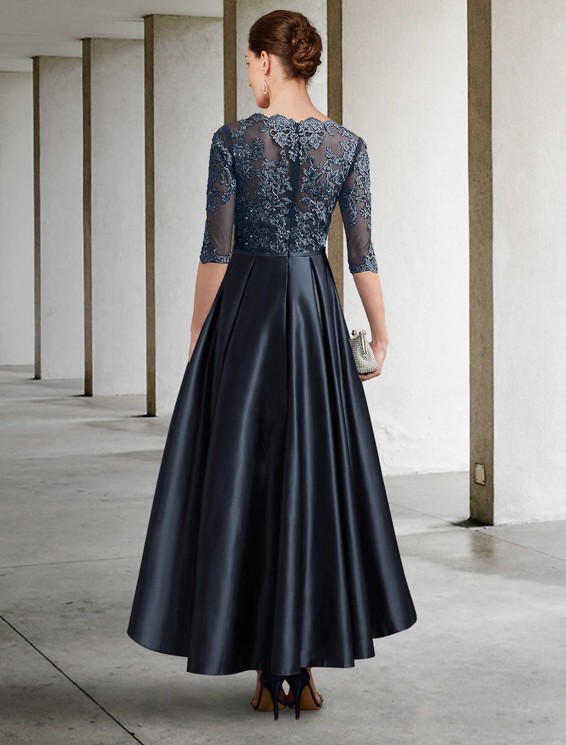Back view of the A-Line formal dress, showing lace and pleat details.