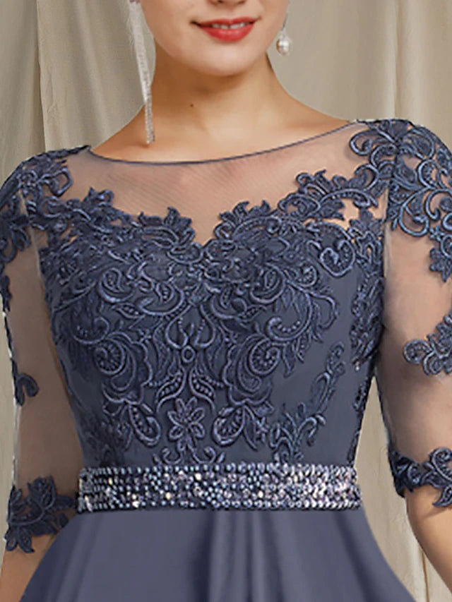 Close-up of crystal and applique details on a floor-length formal dress.
