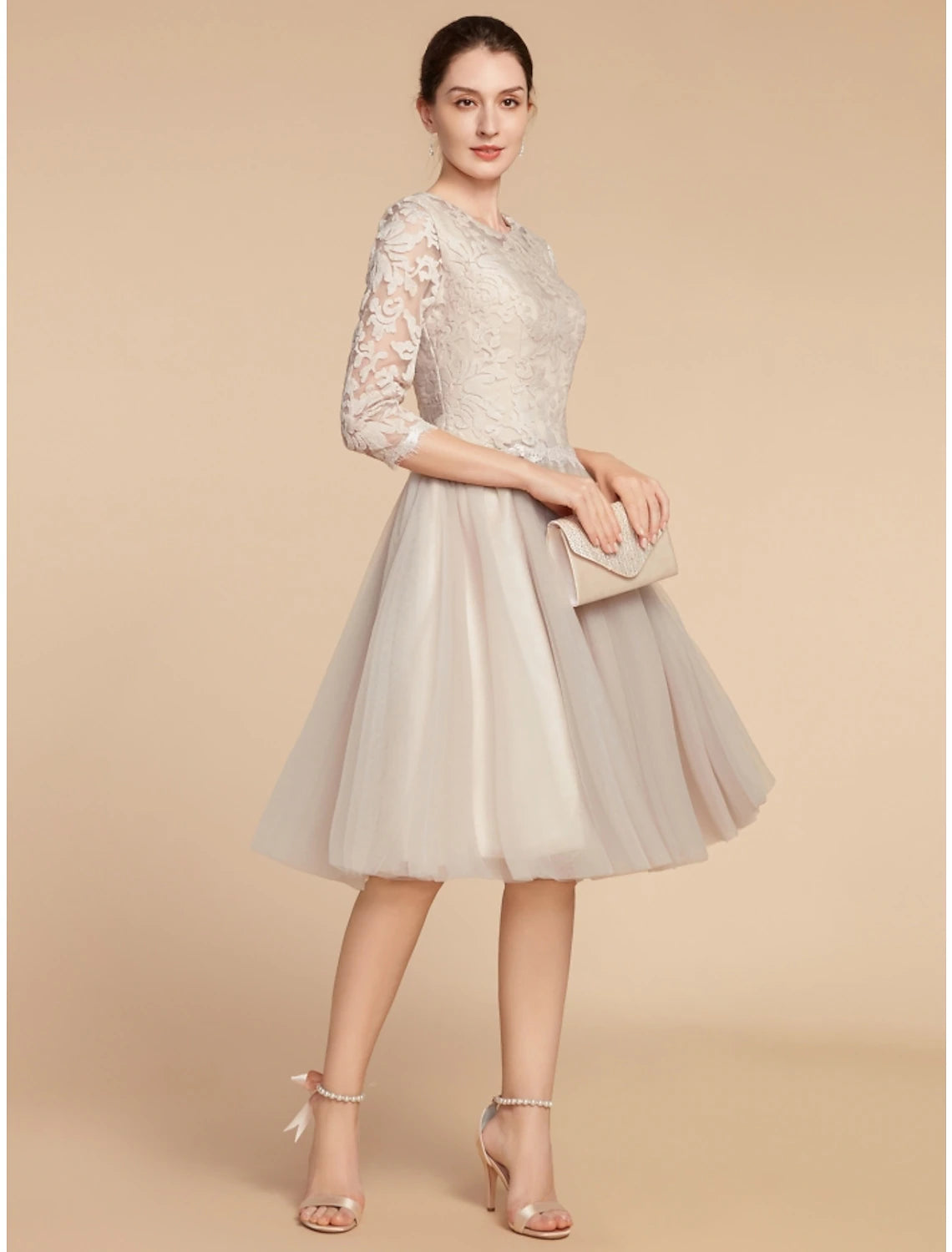 Textured lace and pleated skirt detail of the formal dress.
