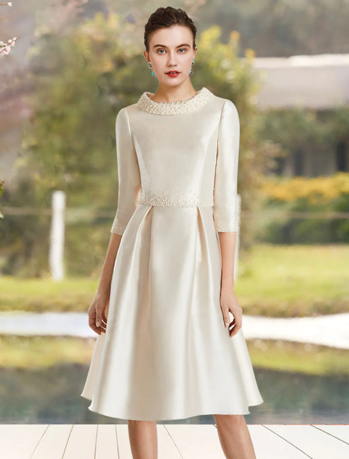Elegant A-line satin dress with jewel neck and half sleeves, front view.