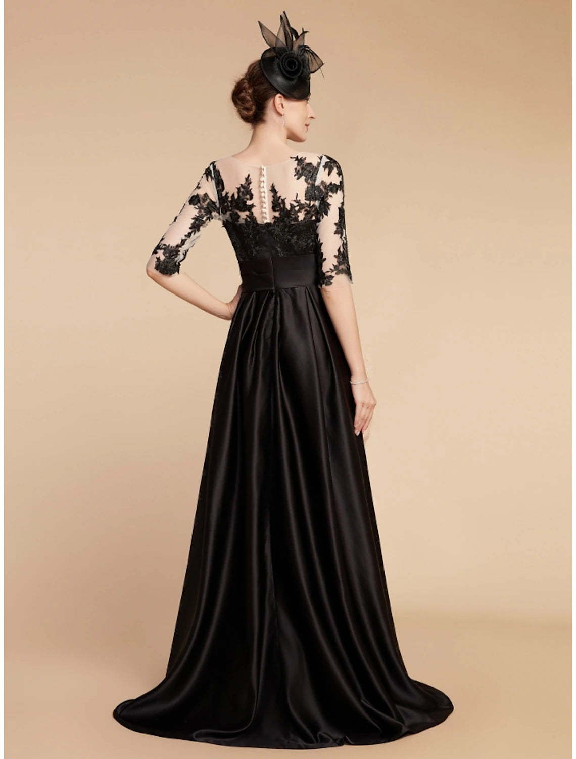 Back view of the A-line satin lace gown with sweep train.