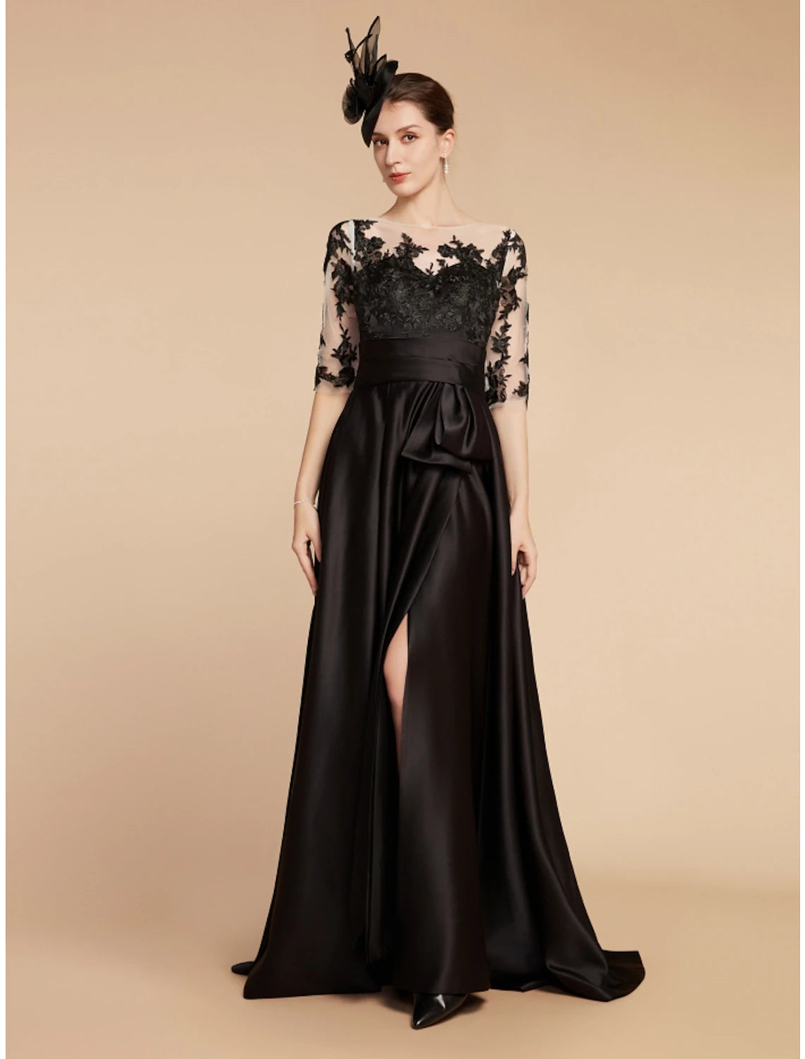 Model wearing the elegant party gown with a graceful sweep train.