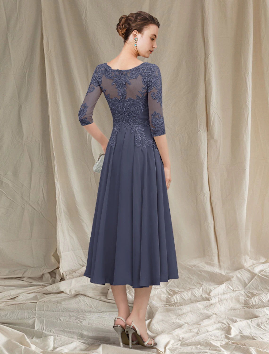 Close-up of the A-Line gown showing chiffon lace, pleats, and appliques.