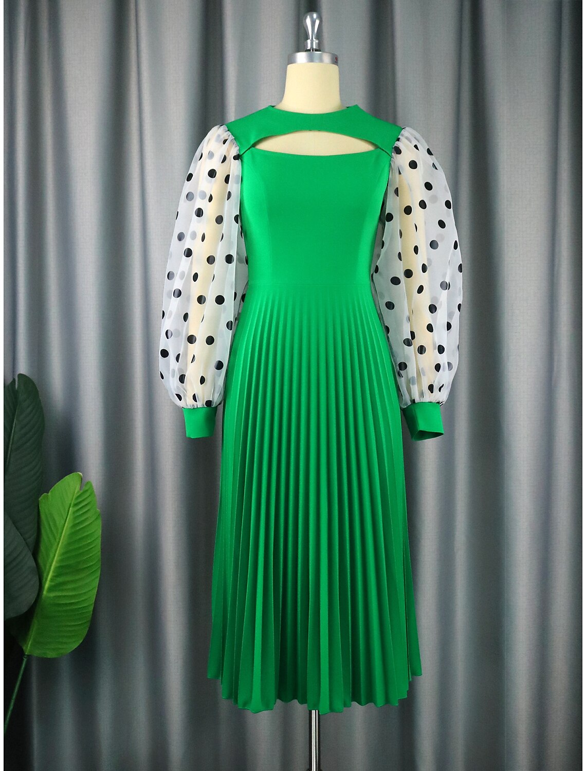 Elegant A-line tea-length party dress with jewel neck and long sleeves.