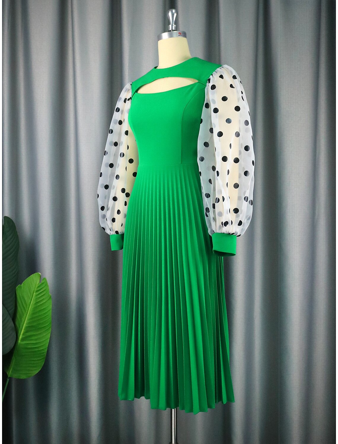 Back view of a chiffon A-line dress featuring cut-out details and pleats.