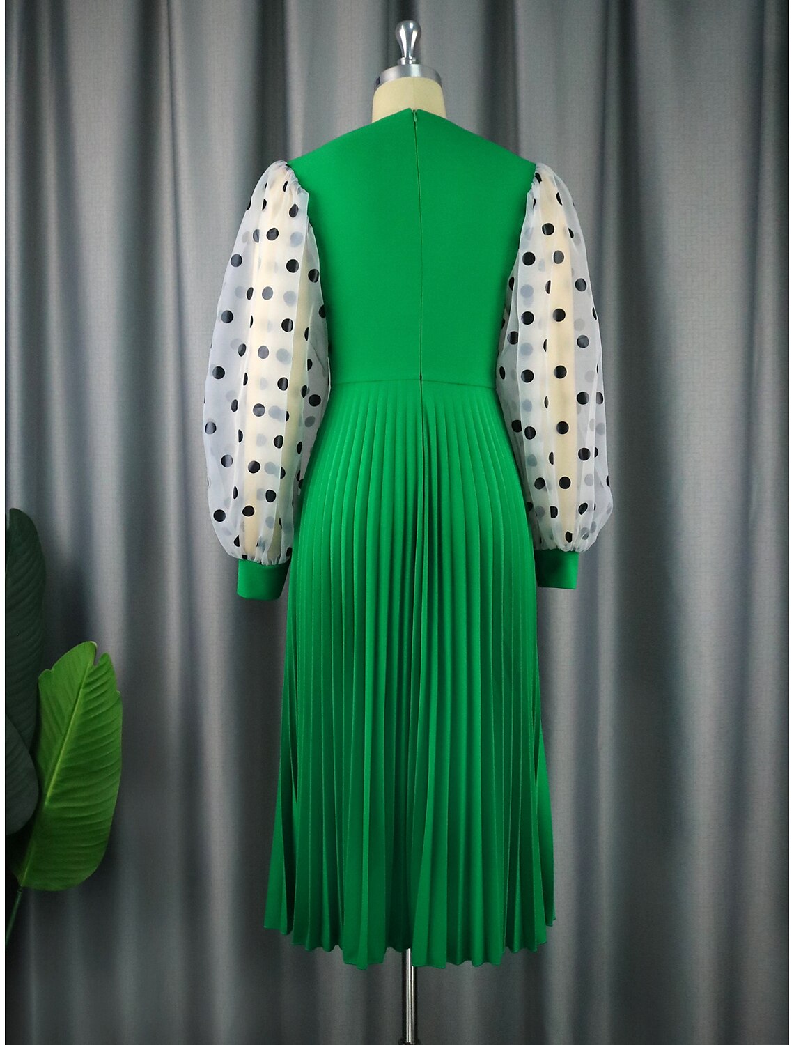 Side profile of a long sleeve A-line cocktail dress in flowing chiffon.