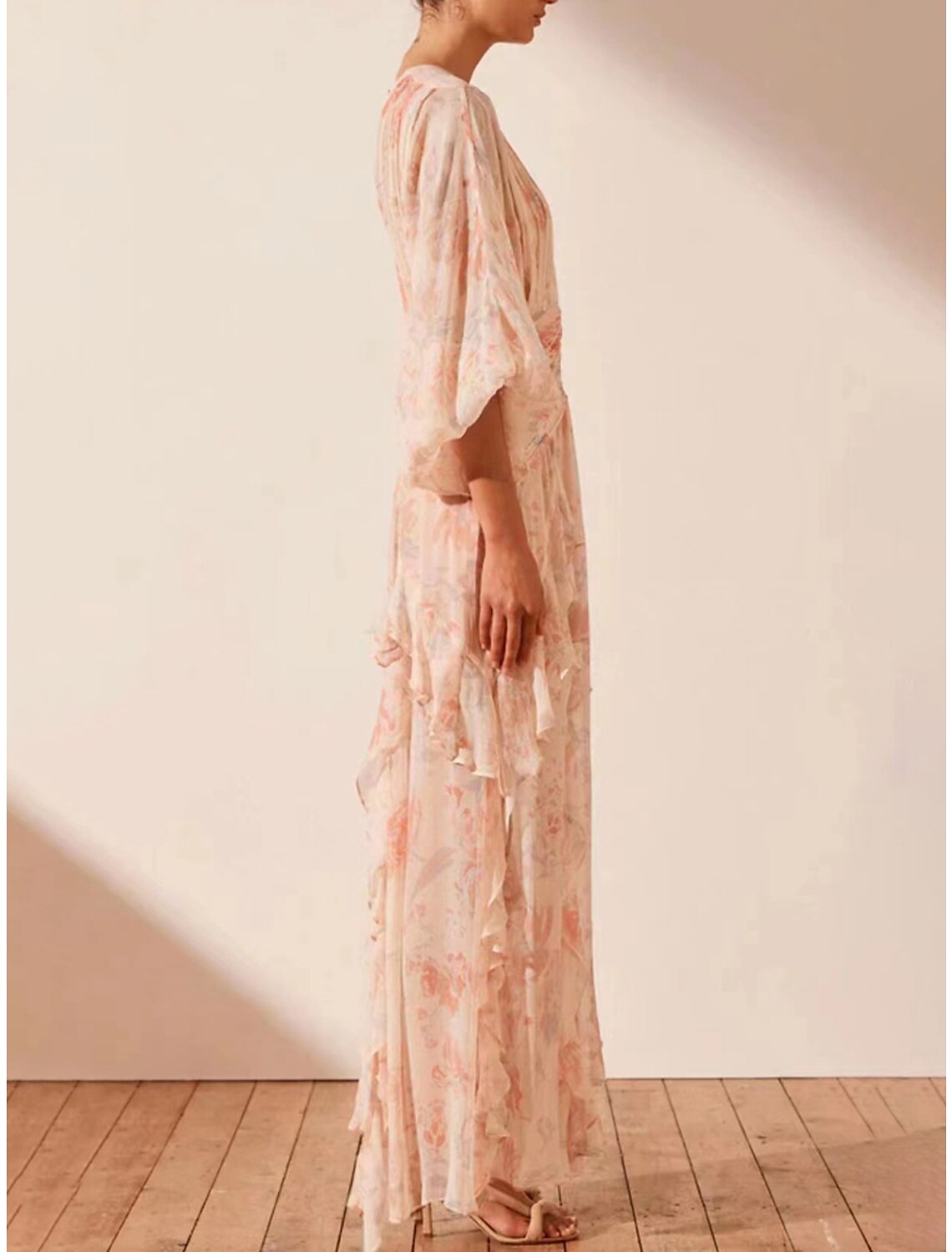 Close-up of the floral print and ruffle details on the A-line maxi dress.