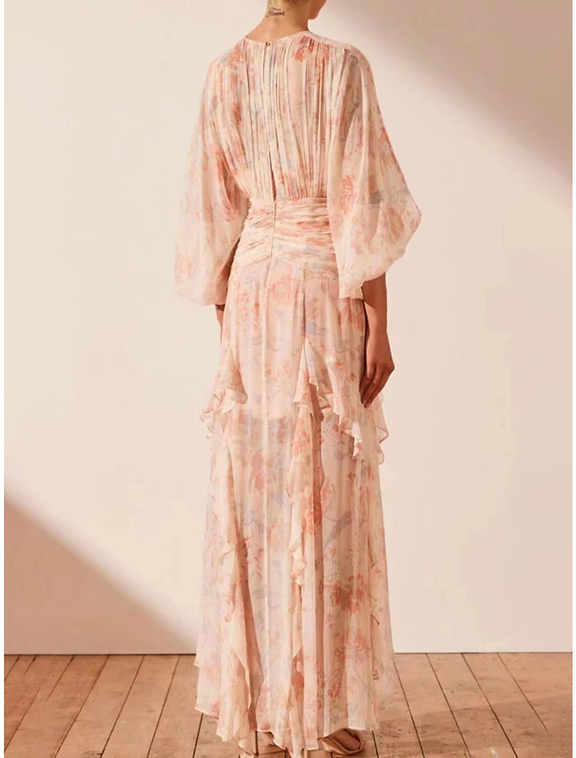 Back view of the A-line floral maxi dress, highlighting the floor-length design.