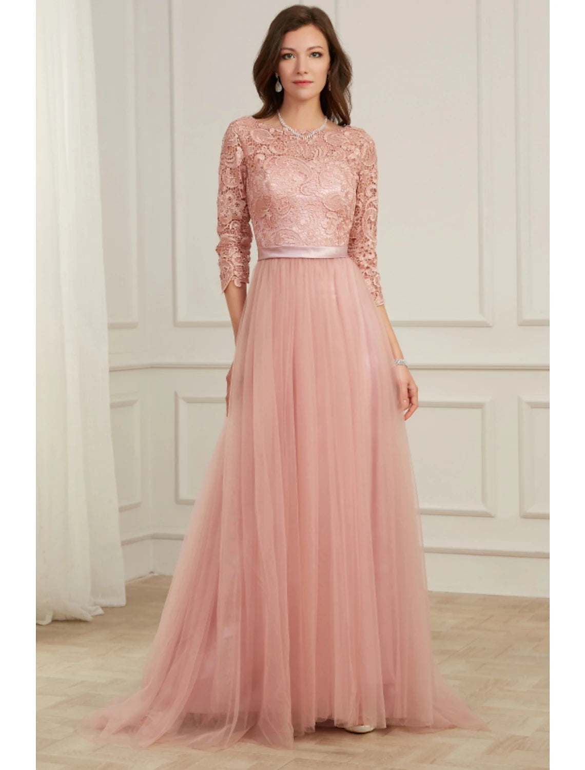 Elegant A-line evening gown with long sleeves and jewel neck, featuring lace appliques.