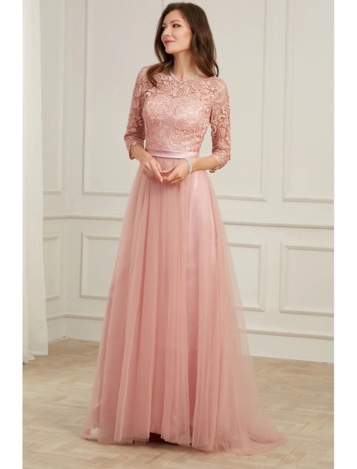 Close-up of the lace and applique embellishments on the long sleeve evening gown.