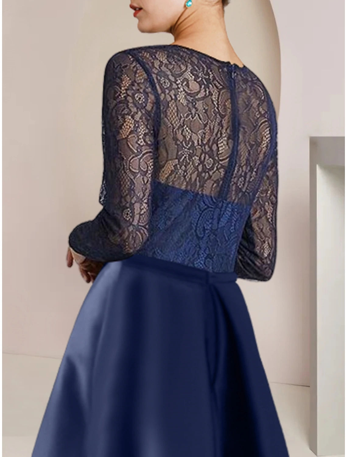 Back view of the elegant Mother of the Bride dress, highlighting lace sleeves and train.