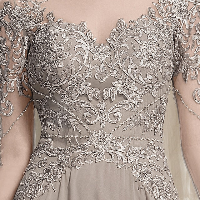 Back view of the floor-length chiffon lace gown with delicate appliques.