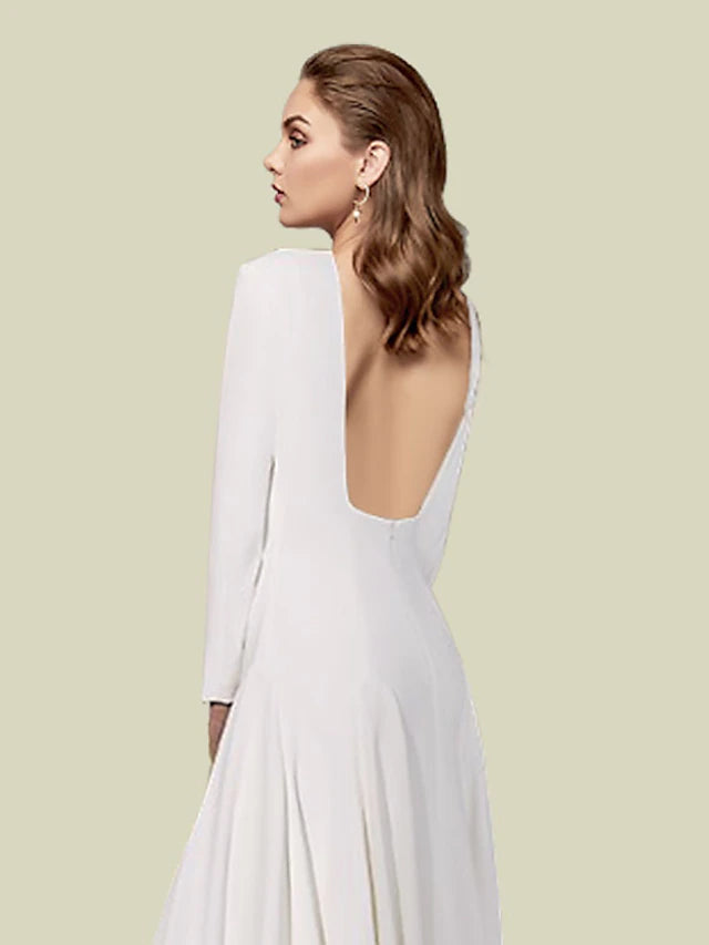 Close-up of the jewel neck and long sleeves on the satin gown.