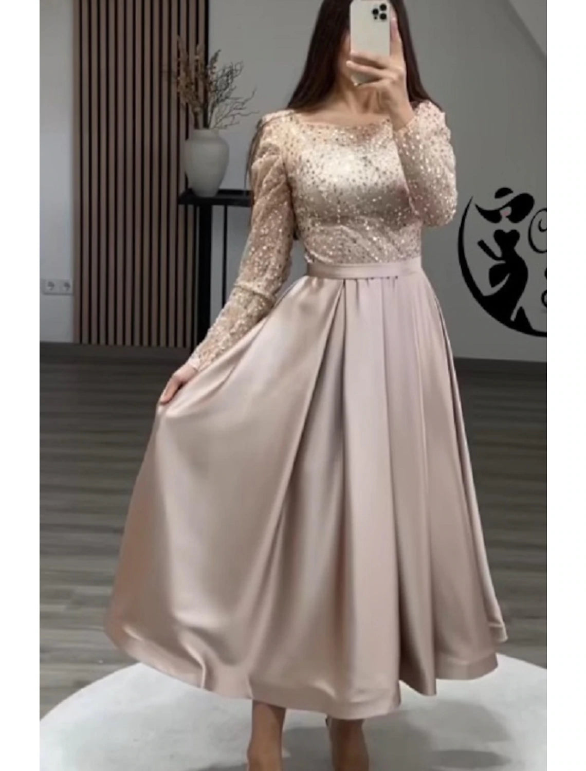 Elegant A-line evening gown with long sleeves and jewel neck, front view.