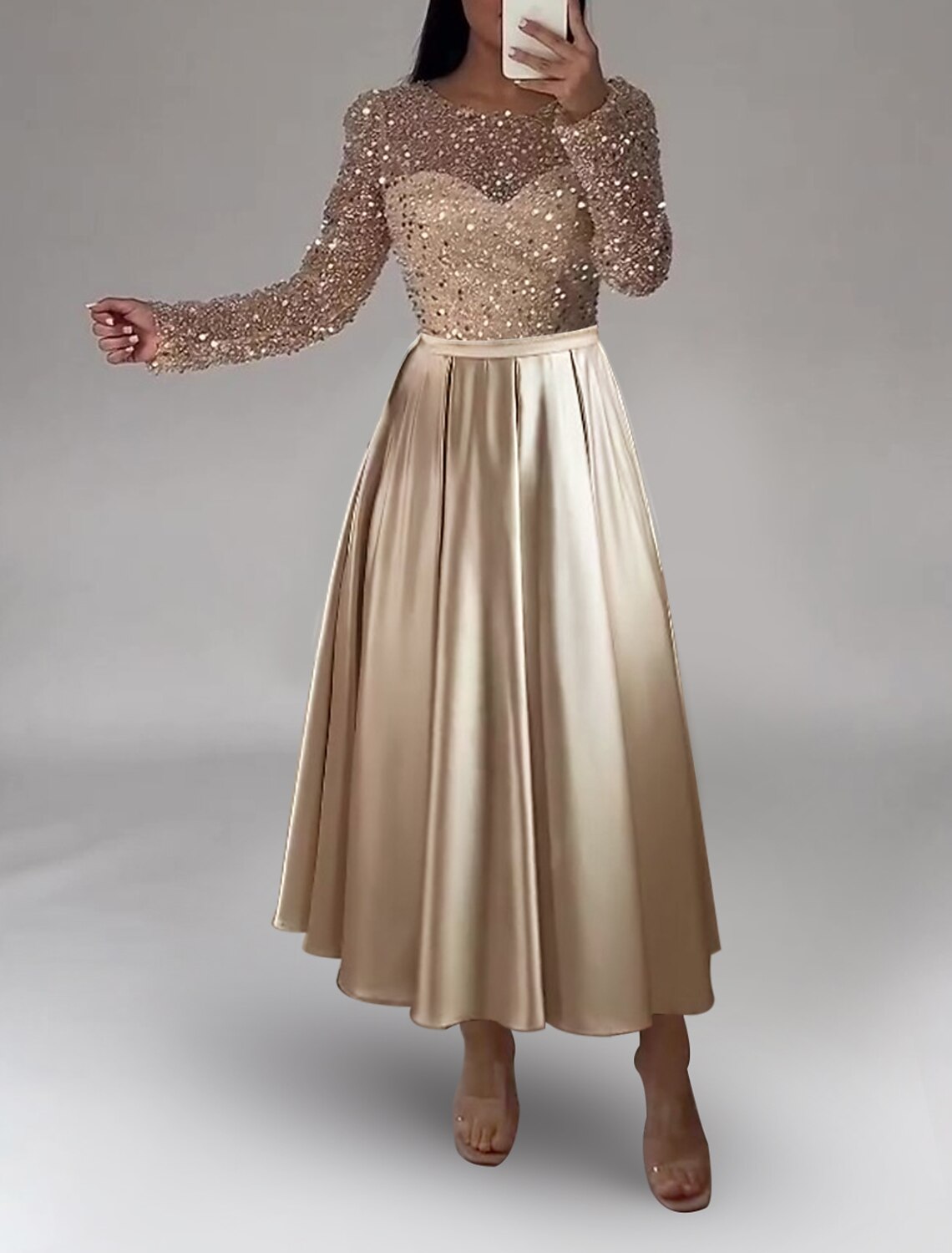 Close-up of the satin A-line gown, showcasing pearl and sequin embellishments.