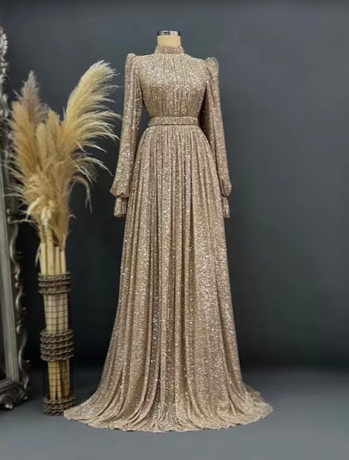 Elegant A-line sequined black evening gown with long sleeves and jewel neck.