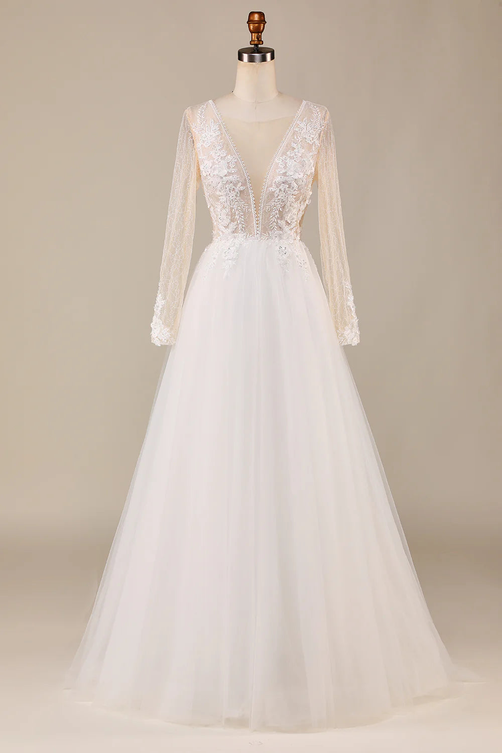 Elegant ivory long sleeve wedding dress with tulle skirt and lace details.