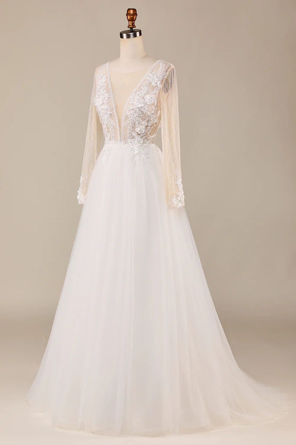 Bride wearing a beautiful ivory long sleeve wedding dress with a full tulle skirt.