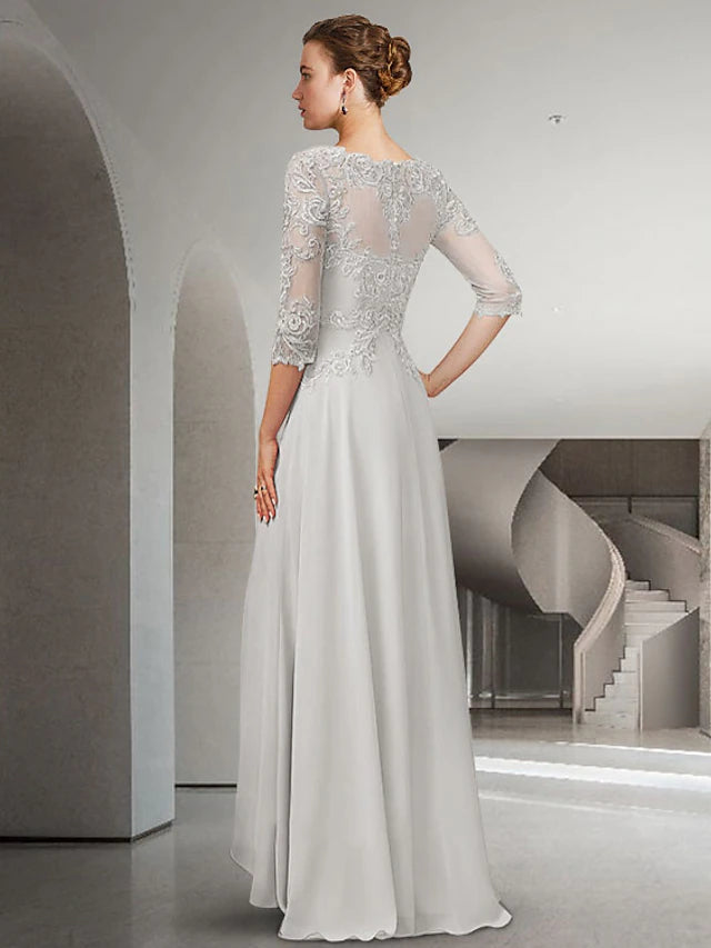 Back view of an A-line Mother of the Bride dress with a high-low hem and sweep train, showcasing lace appliques.
