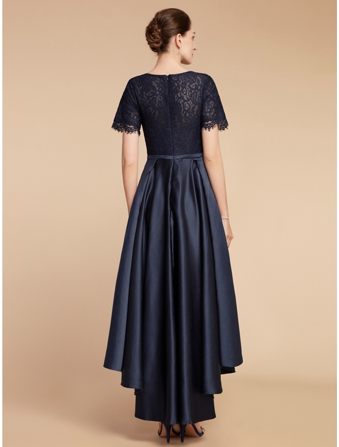Side view of a navy A-line satin lace dress with ruched details.