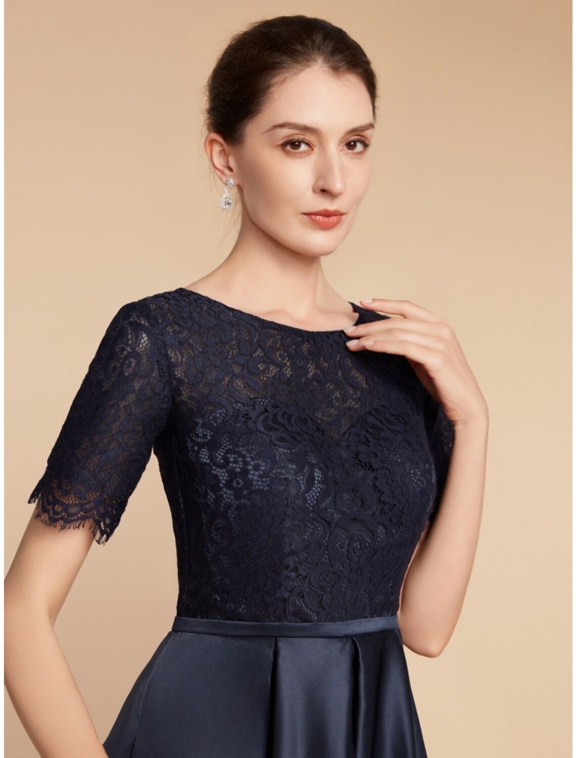 Back view of an elegant navy formal gown with a flowing A-line skirt.