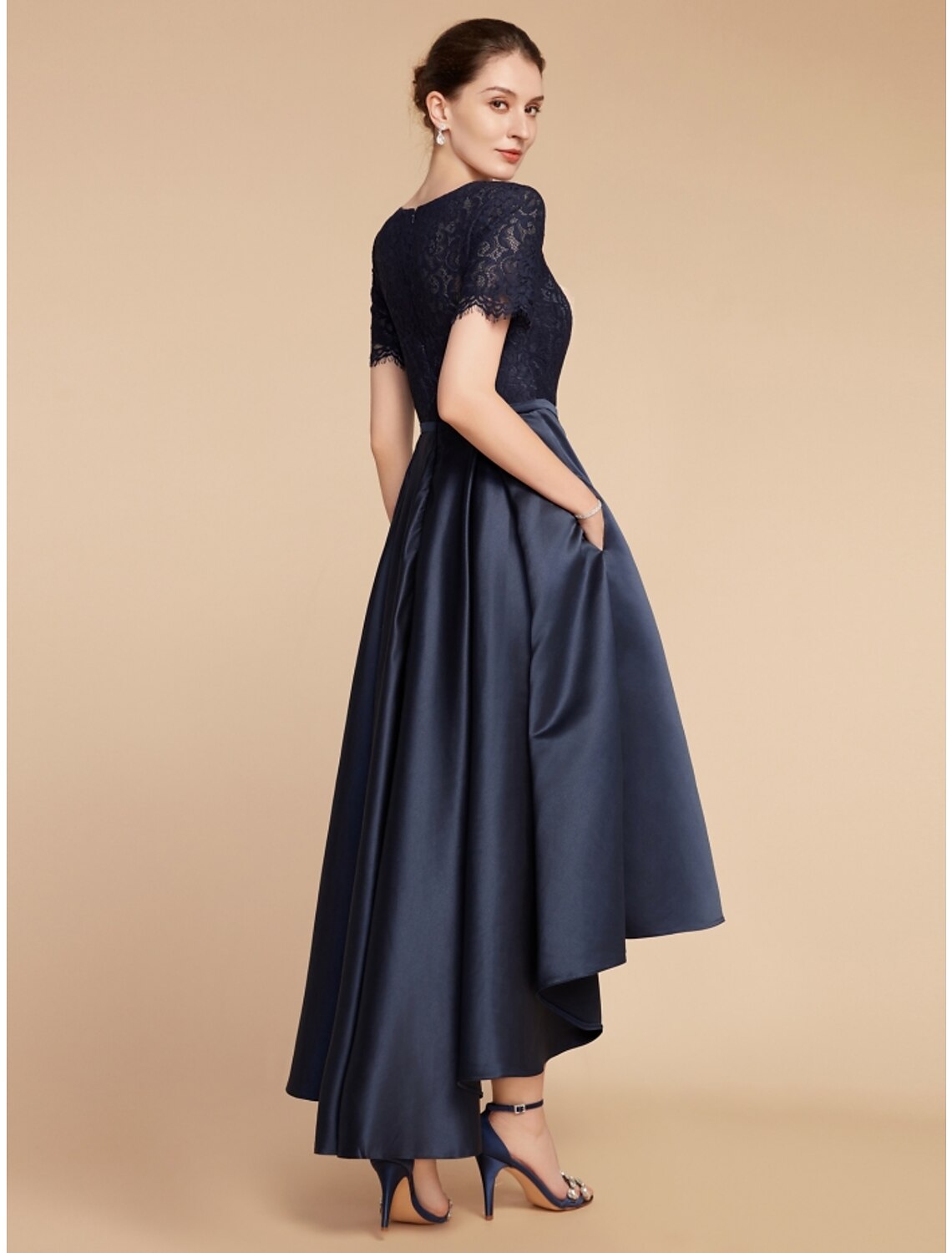 Close-up of the satin and lace fabric with asymmetrical ruching on a formal dress.