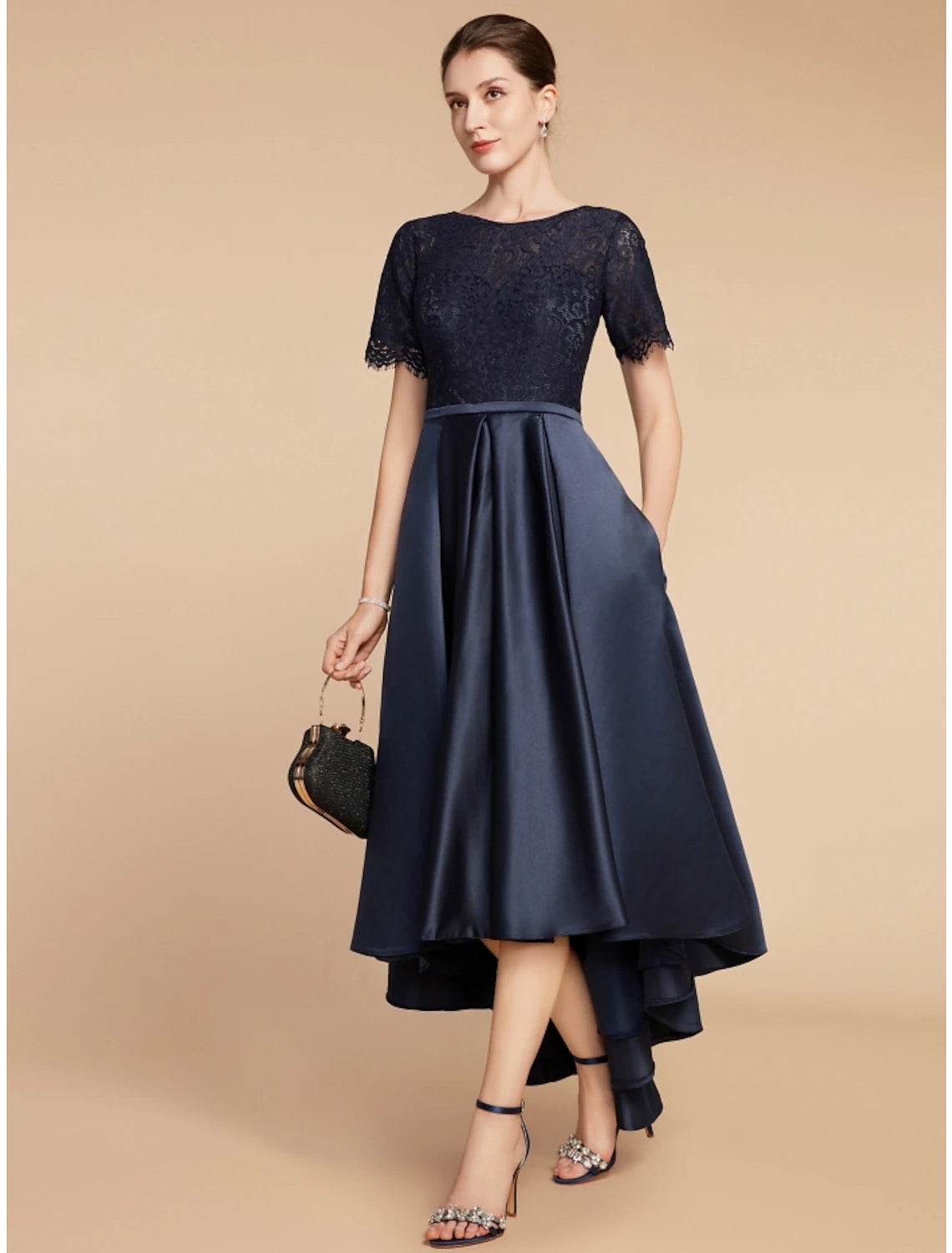 Model wearing a sophisticated navy A-line dress, suitable for wedding guests.