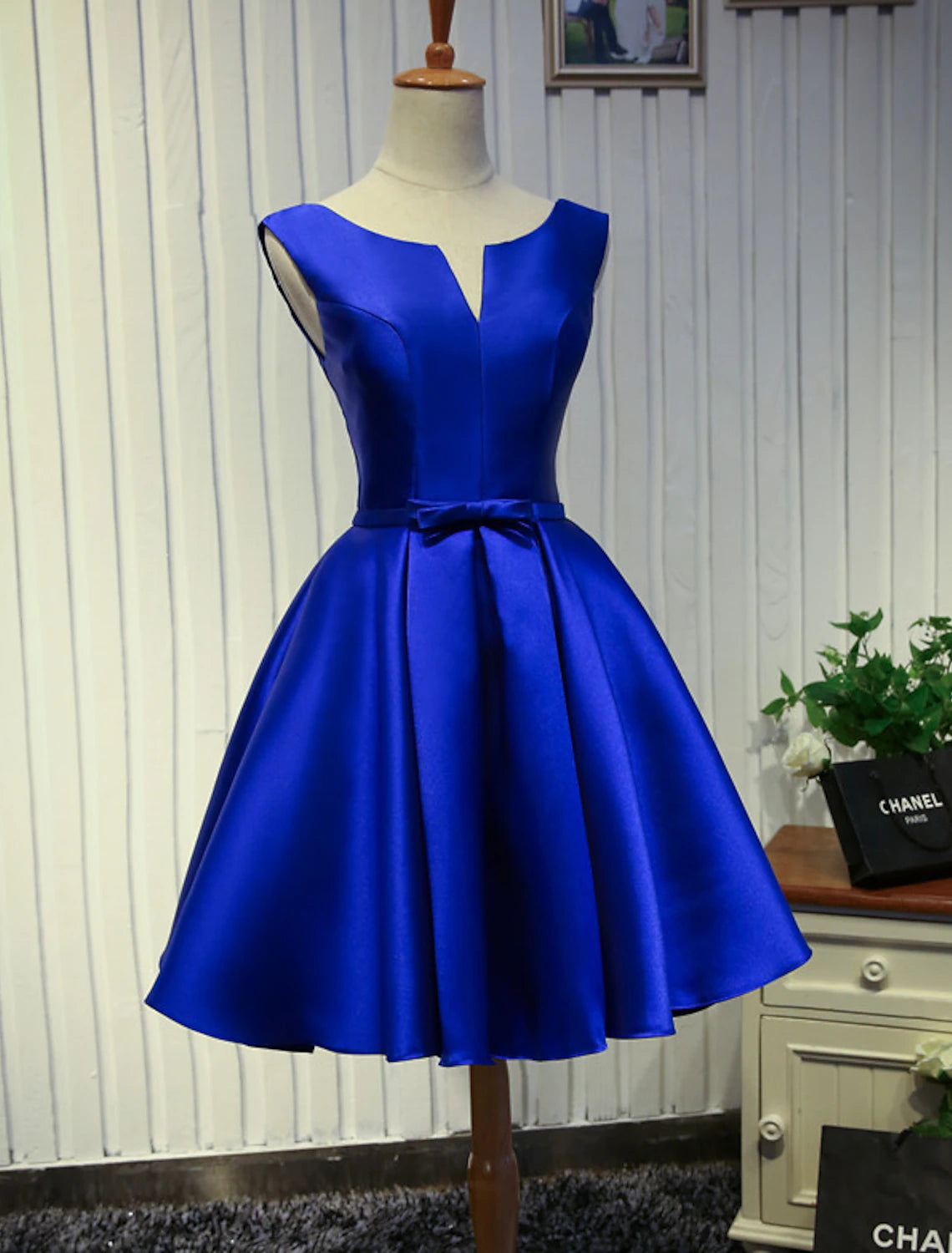 A-Line satin homecoming dress with jewel neck and butterfly detail.