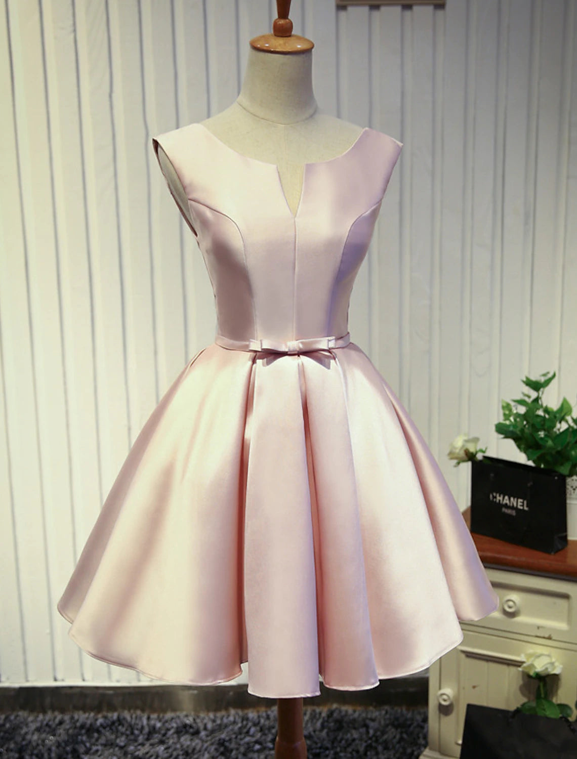 Back view of A-Line satin dress showing backless design and butterfly accent.