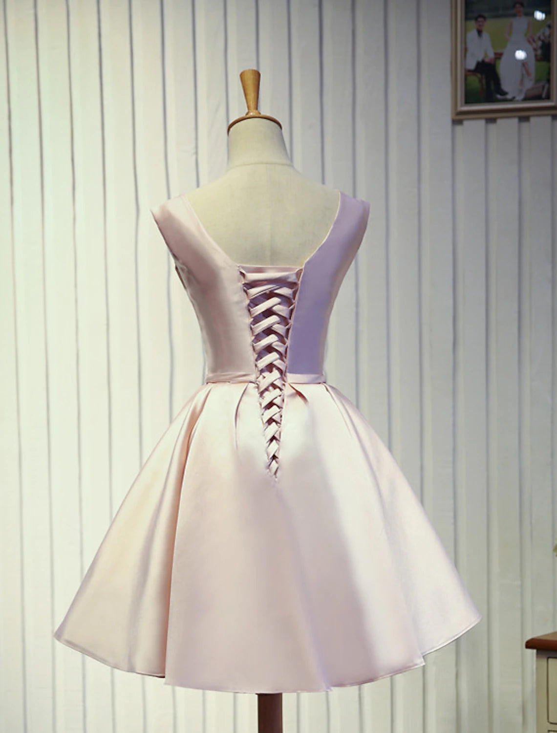 Side view of knee-length A-Line satin dress.