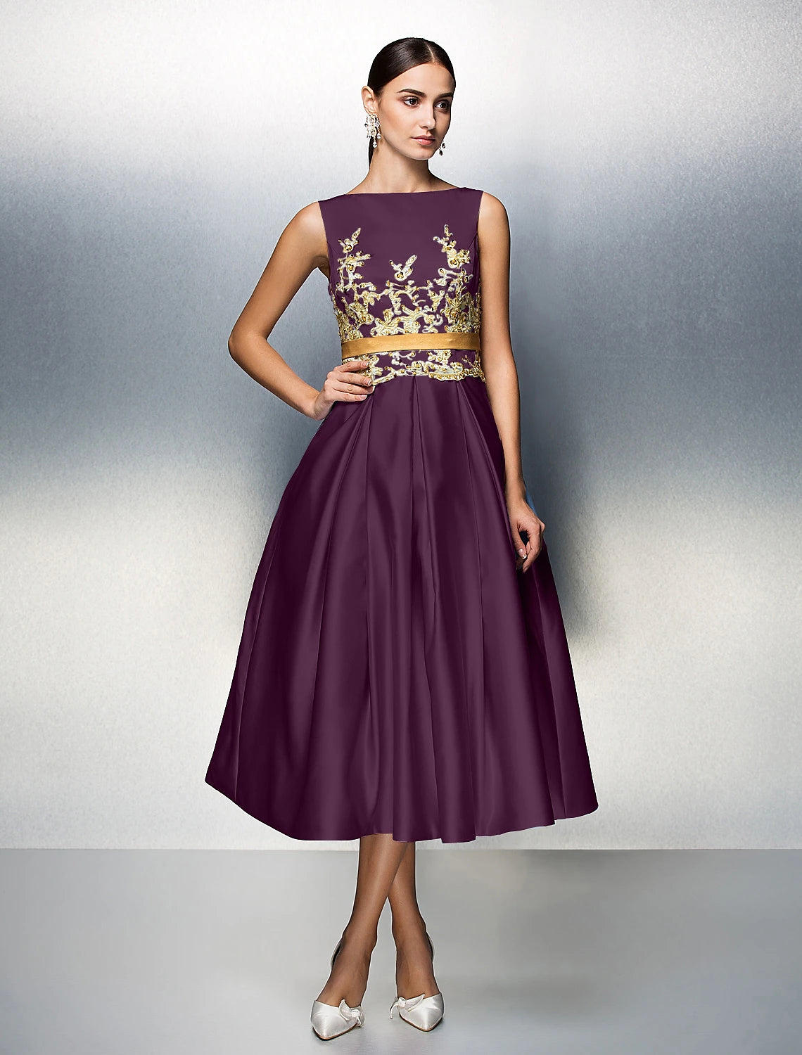 Close-up of jewel neck and applique details on satin dress.