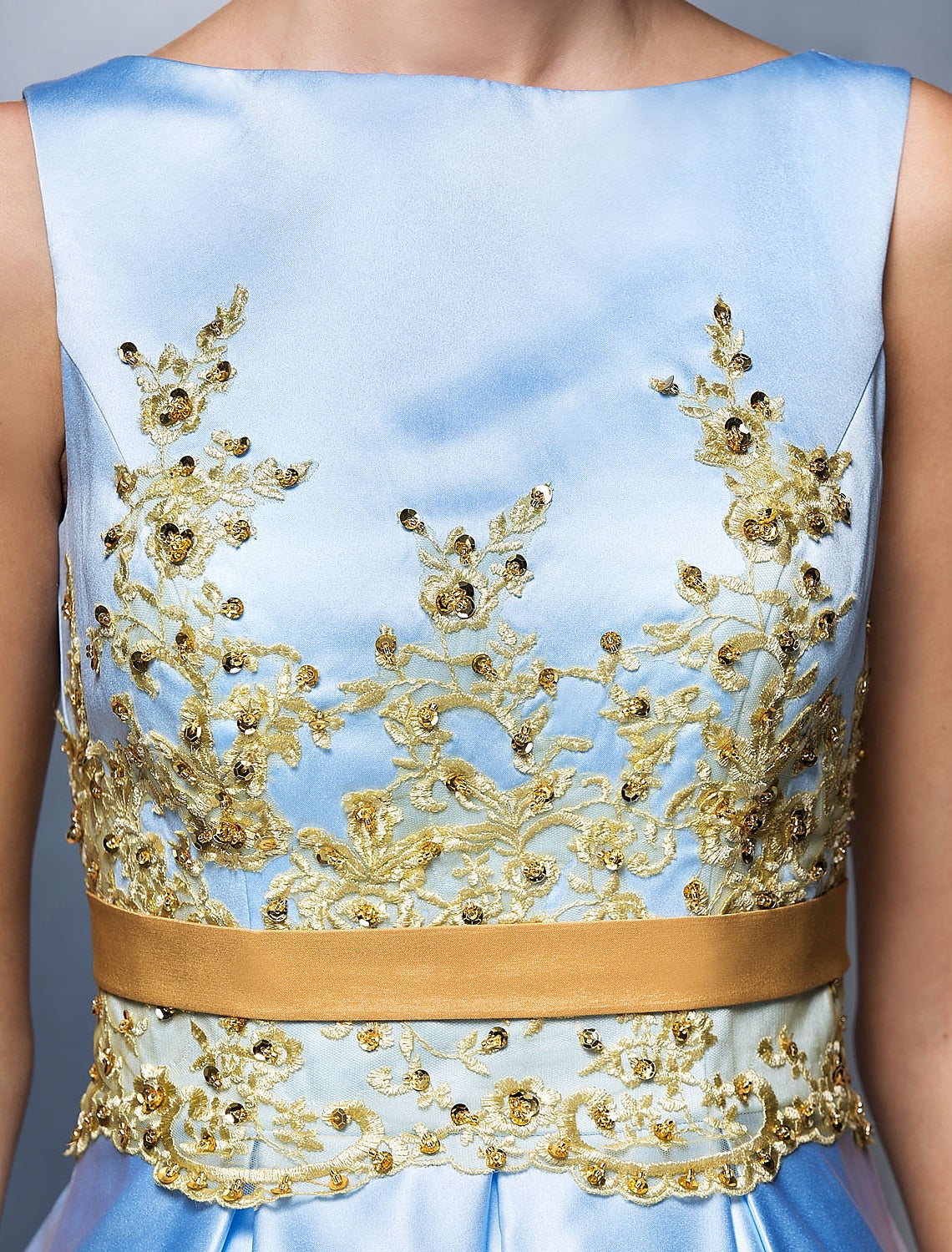 Detail of the pleated skirt and appliques on the tea length dress.