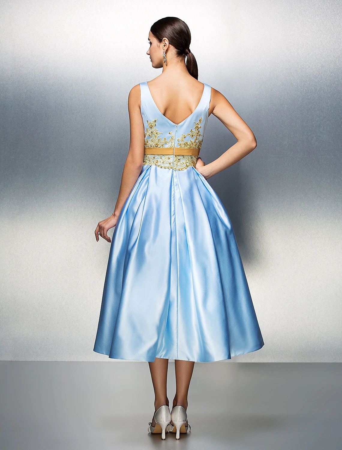 Elegant A-Line dress with V-back and flowing tea length skirt.