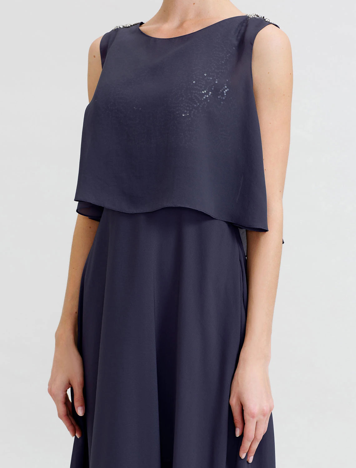 Detail of the sashes/ribbons and delicate beading on the chiffon dress.
