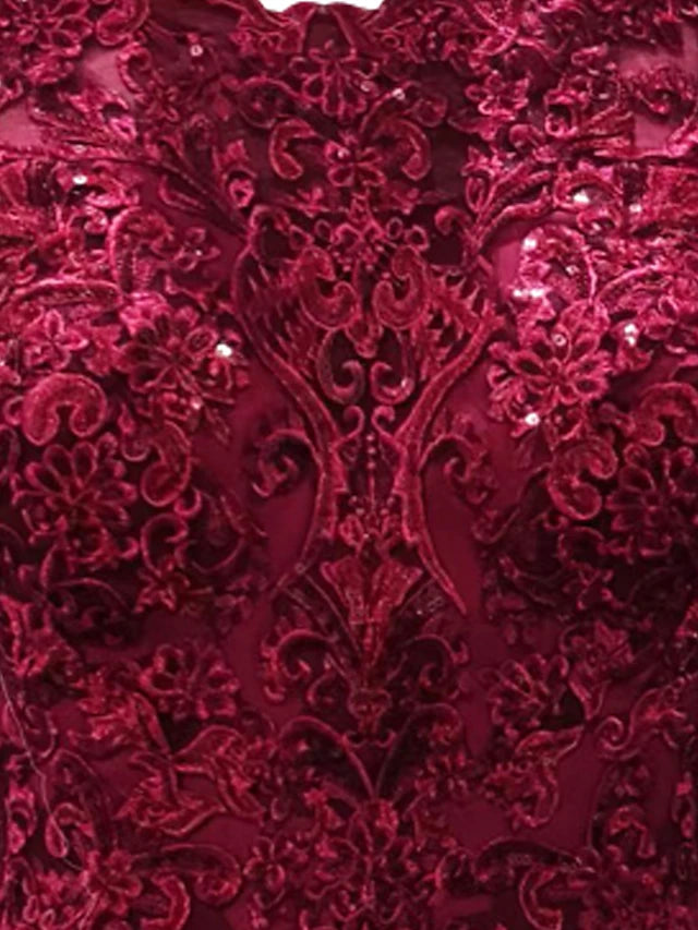 Close-up of the lace appliques and jewel neckline on the Mother of the Bride dress.
