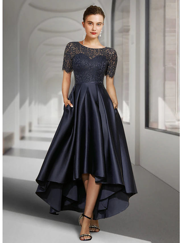 Elegant A-line mother of the bride dress with jewel neck, short sleeves, and high-low tea length hem.