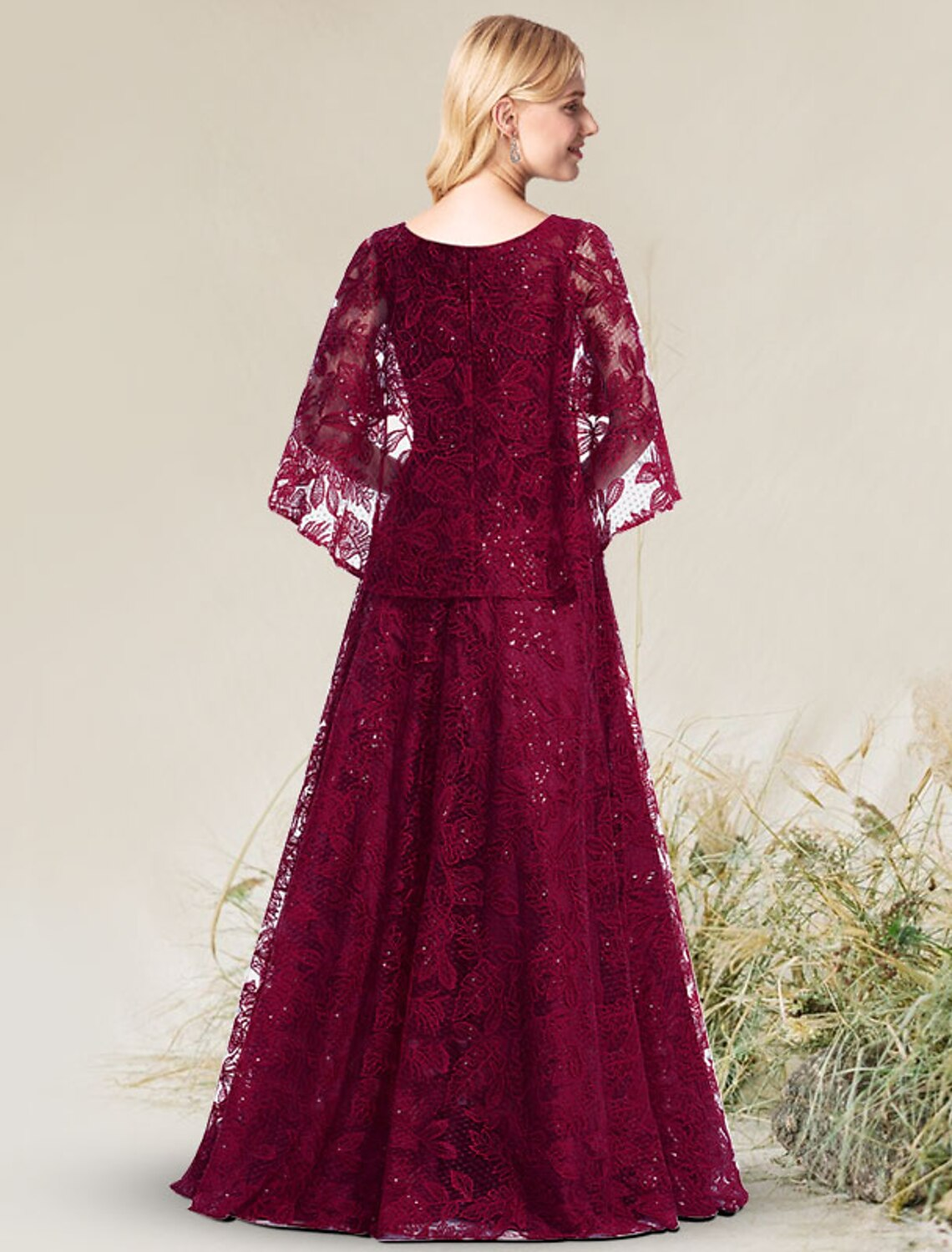 Back view of the floor-length A-line dress featuring intricate lace detailing.